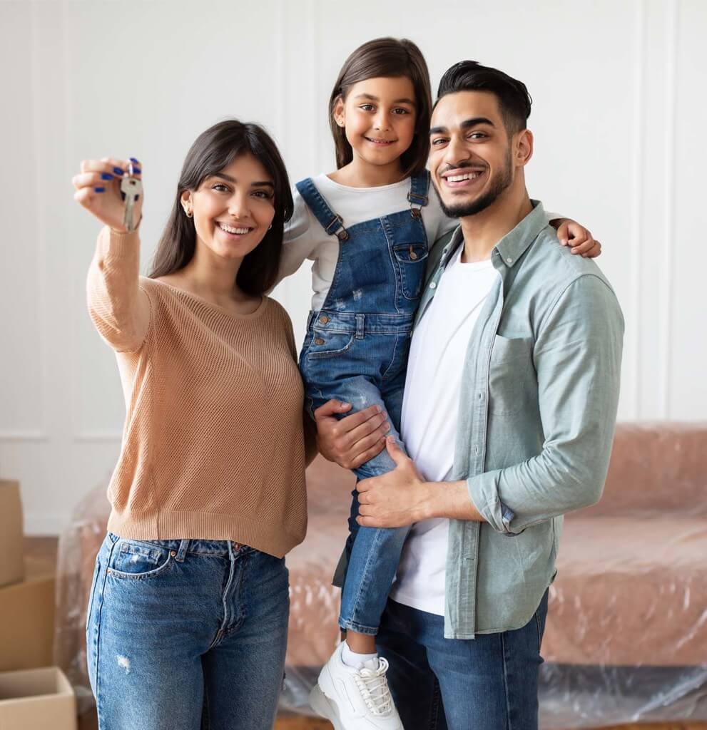 family celebrating owning their own house